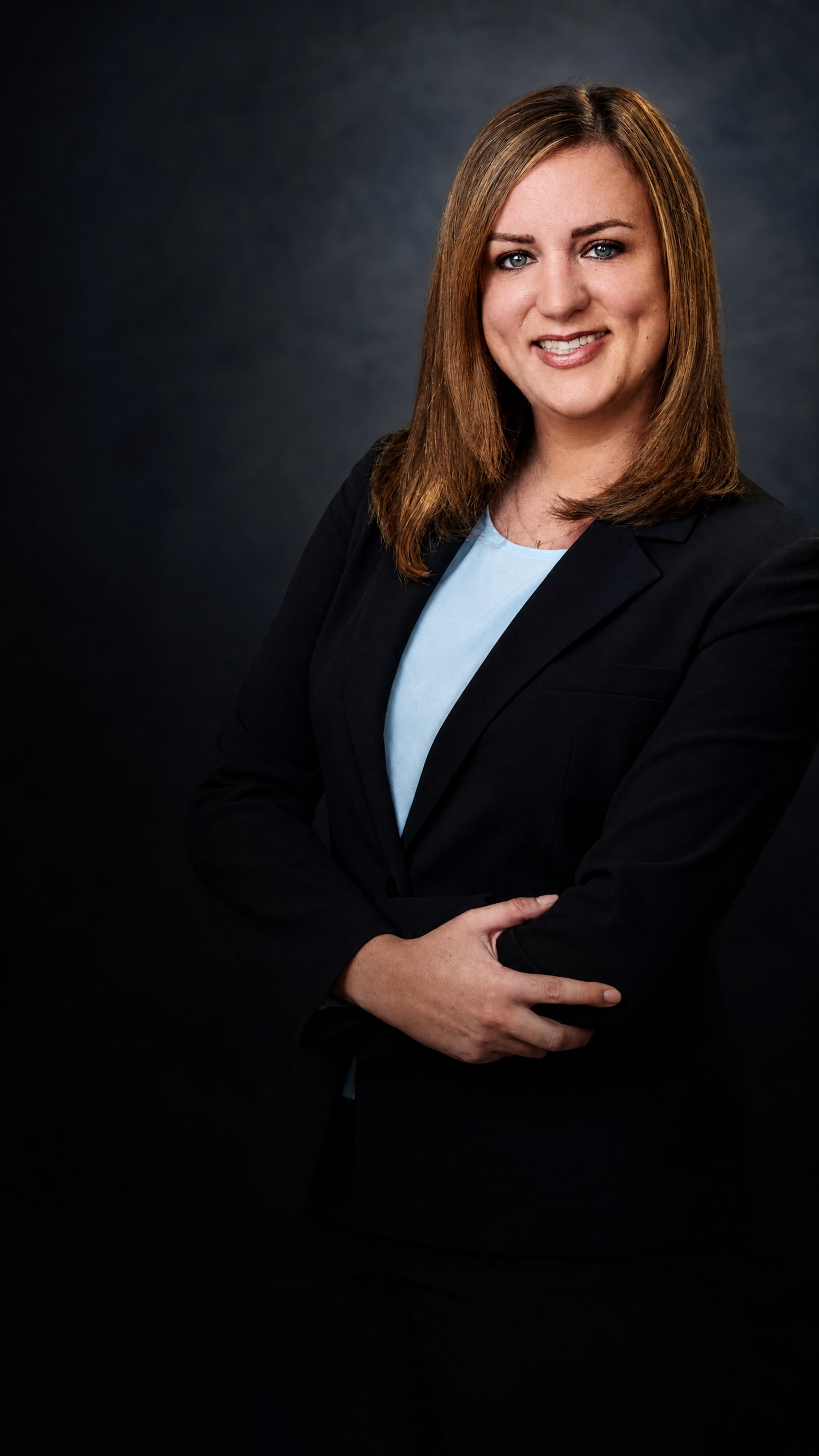 Jessica Turkish in a dark suit against a charcoal background.