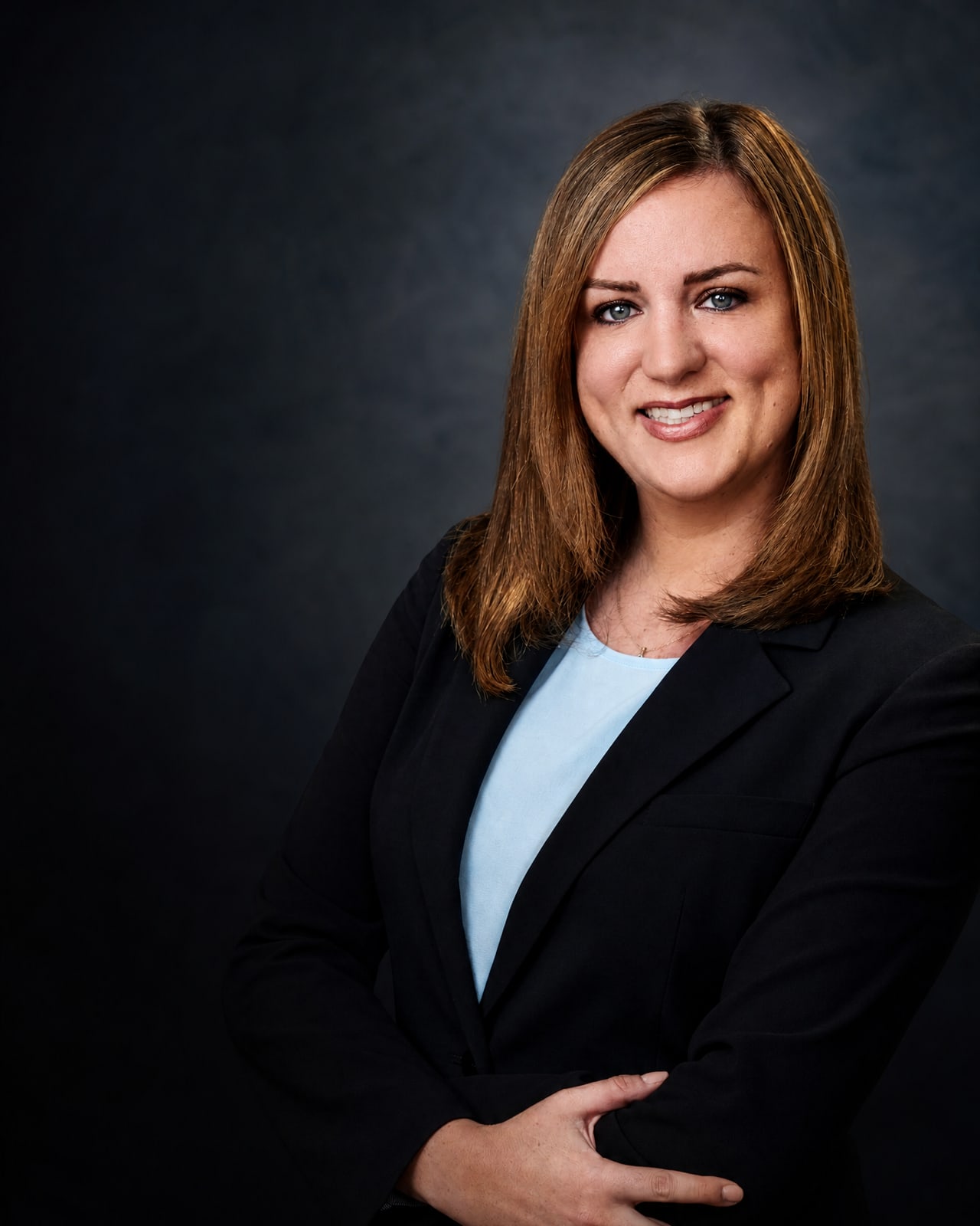 Jessica Turkish in a dark suit against a charcoal background.